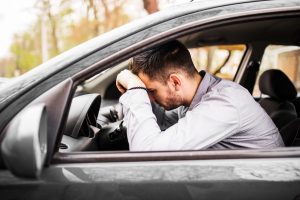 Back Pain While Driving causing lower back discomfort while sitting in a car